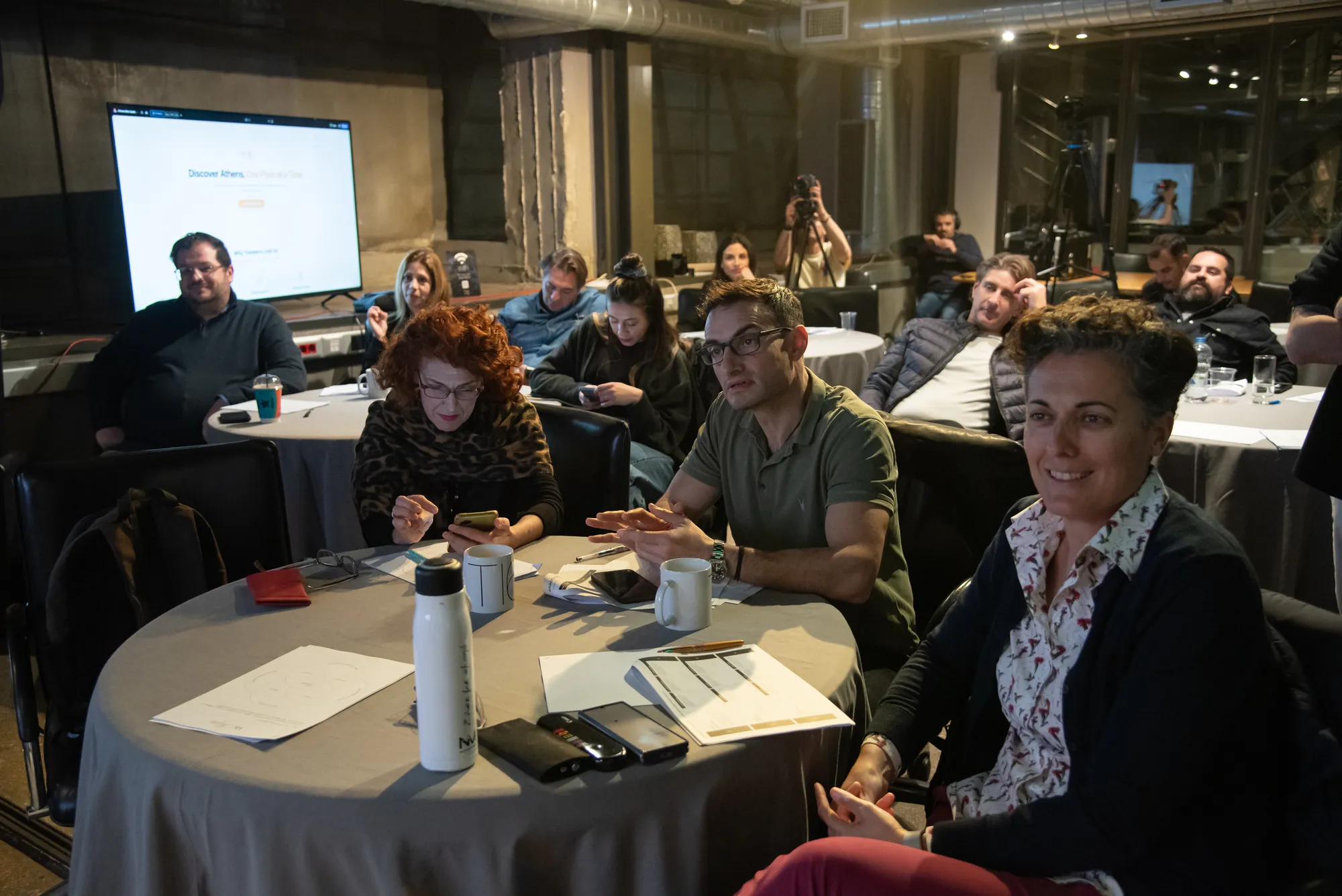 Tables of participants facing the presentation screen